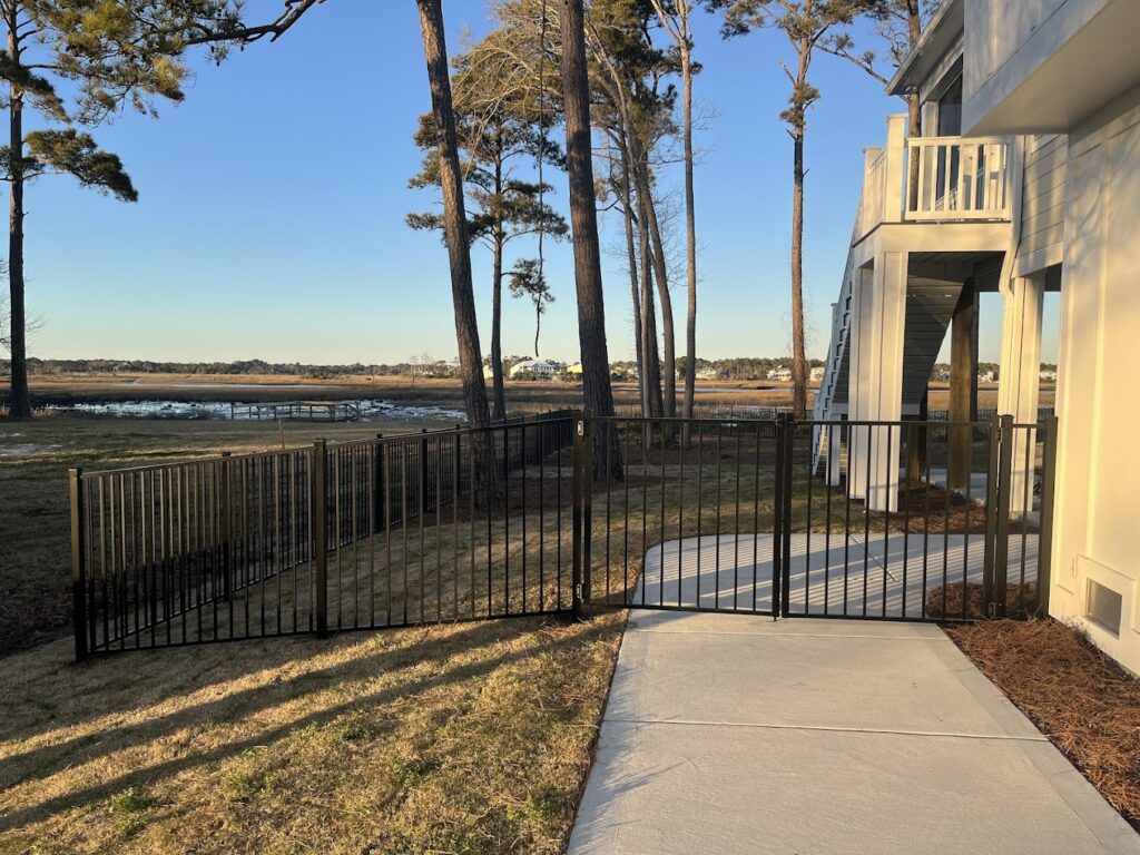 Black metal fence along waterfront property